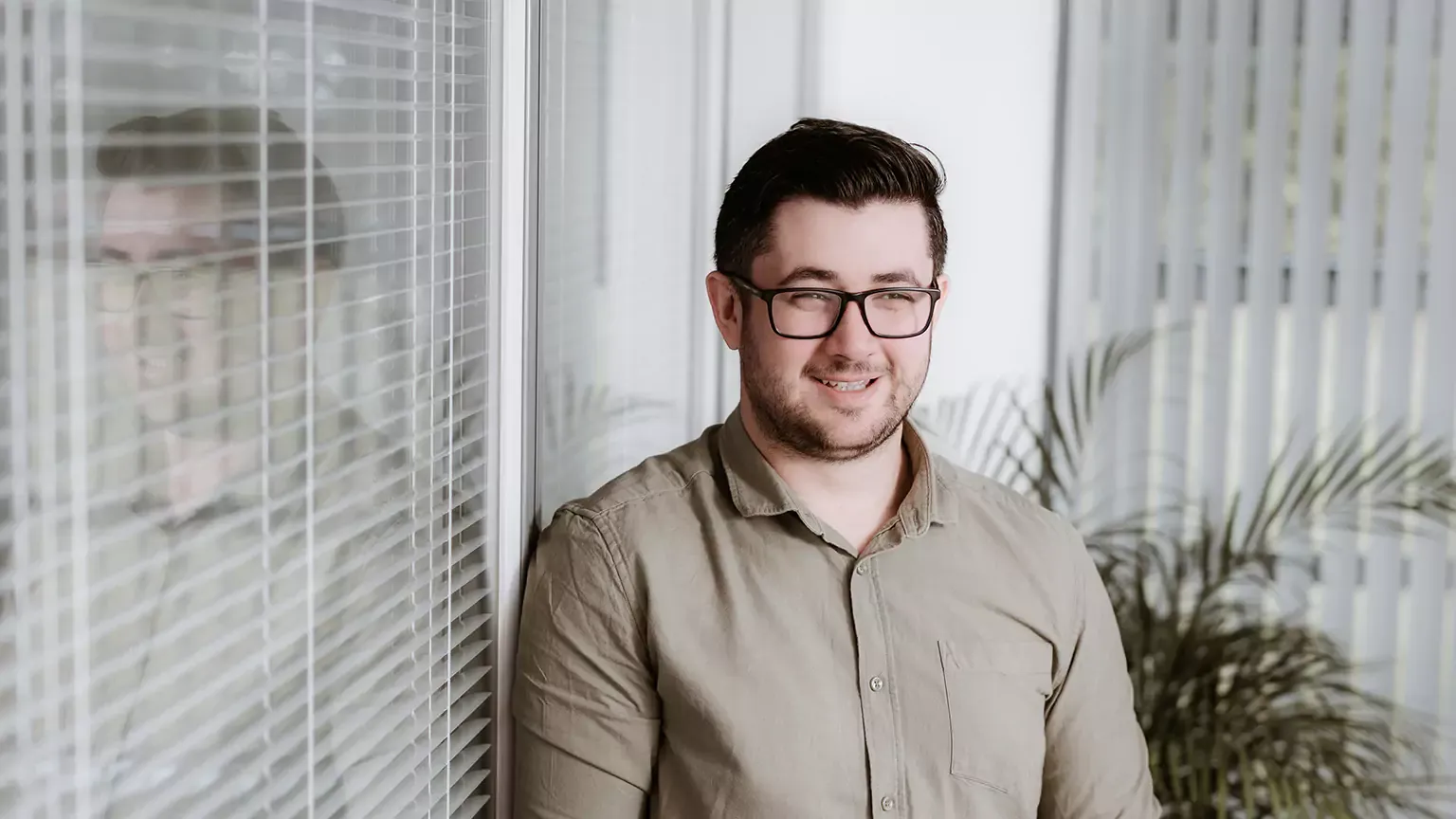 Rob Cipolla standing beside a window